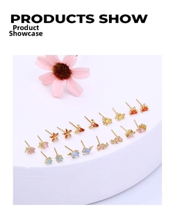 Detailed display of assorted gold-plated ocean stud earrings with colorful zircon stones