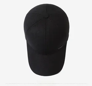 Top view of a minimalist black baseball cap with premium canvas texture and a six-panel crown