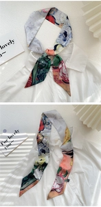 Detail of oil painting style twilly silk scarf tied on a white shirt collar
