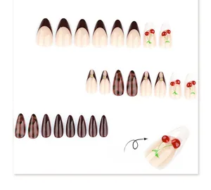 Detail of 3D embossed cherry design on almond press-on nails with tortoiseshell pattern