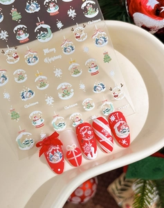 Detailed Christmas nail art stickers featuring snowflakes and reindeers on festive patterns