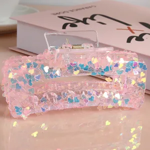 Pink translucent resin hair claw clip with colorful heart glitter and gold spring