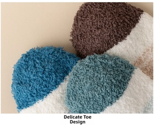 Macro detail of high-quality toe stitching on thick striped coral fleece sleep socks