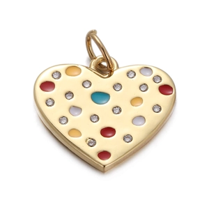 Macro shot of gold heart pendant with colorful enamel dots and sparkling zircons