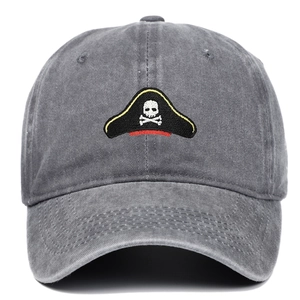 Close-up of pirate skull embroidery on washed grey cotton vintage baseball cap