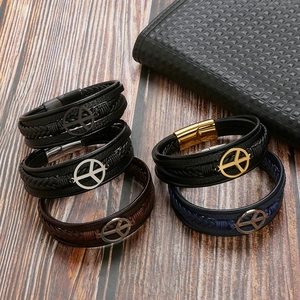 Men's leather woven bracelet with metal peace symbol magnetic clasp on wood background