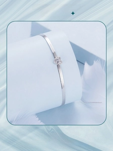 Close-up of S925 sterling silver snake chain heart bracelet with sparkling zircon stone