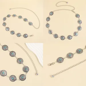 Close-up of Bohemian metal waist chain featuring turquoise inlays and vintage floral carvings