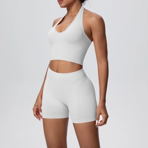 Close-up of seamless white yoga set featuring ribbed texture and halter neck sports bra