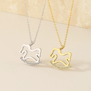 Detailed view of silver and gold plated rocking horse pendants with sparkling crystals
