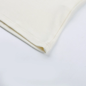 Detailed close-up of soft ribbed knit texture and premium stitching on white lace vest