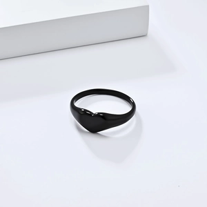 Minimalist black heart-shaped ring in matte stainless steel shown from a top-down view