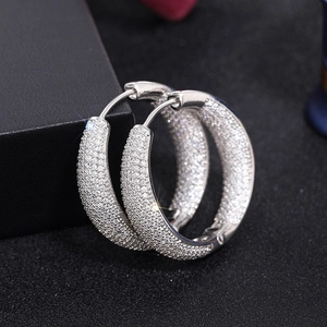 Macro view of silver hoop earrings with shimmering micro-pave cubic zirconia crystals