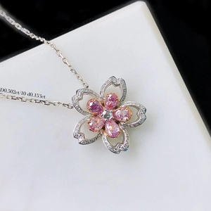 Pink sakura flower pendant necklace with diamond accents and silver chain in high detail