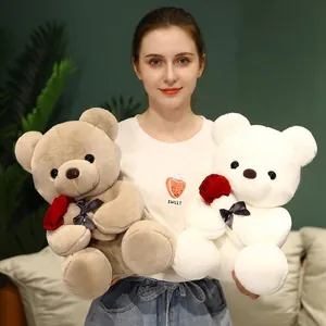Brown and white teddy bears with red roses and black bows for Valentine gift