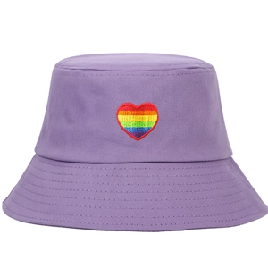 Close-up of rainbow heart embroidery detail on purple cotton canvas bucket hat
