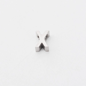 Macro detail of a brushed silver stainless steel letter X pendant with a 1.8mm hole