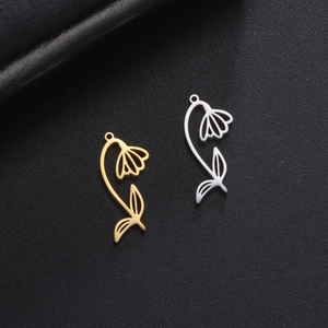 Gold and silver hollowed flower pendant necklaces with stem and leaf on a dark texture