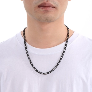 Close-up of a black stainless steel link chain necklace on a model wearing white t-shirt