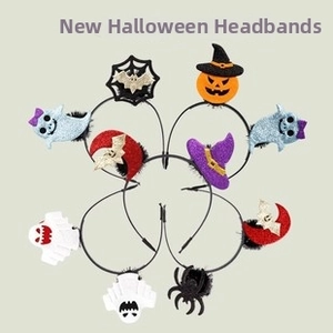 Detail of glitter Halloween headbands featuring pumpkin, bat, and ghost decorations