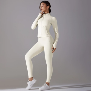 Close-up of cream white fitness set with thumbhole sleeves and high waist leggings