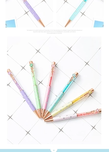 Detail of crystal-filled pens with floral clips and pastel floral printed barrels