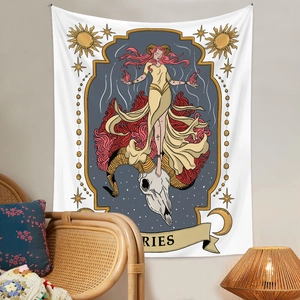 Detail of Aries Zodiac tapestry with skull and moon art in a boho style room setting