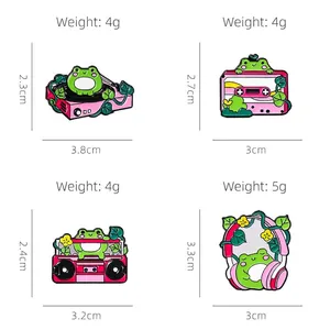 Cute green cartoon frog enamel pins set with retro music themes and pink details