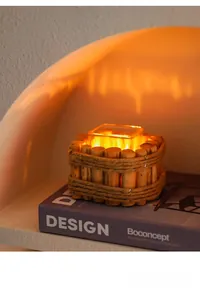 Close-up of driftwood candle holder with jute rope and glass insert on a decorative book