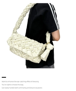 Detail of cream woven shoulder bag with cloud shape and knotted braided strap design