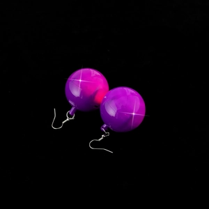Close-up of purple disco ball earrings with reflective surface and silver metal hooks