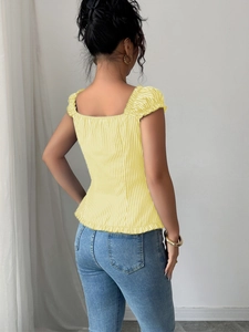 Detail view of the back of a yellow striped short sleeve blouse with puffy sleeves