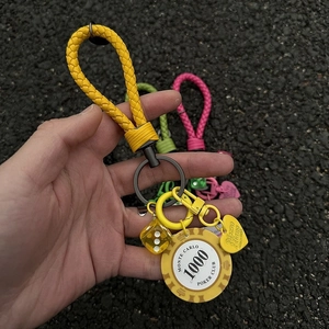 Lucky chip keychain with yellow braided rope, poker dice, and heart charm accessory