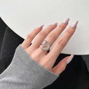 Detail shot of a silver S925 ring featuring a crescent moon and star with zircon pavé