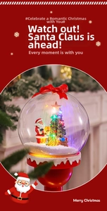 Close-up of lighted Christmas snow globe with Santa Claus and festive red bow detail
