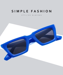 Detail view of bold blue rectangular thick frame sunglasses with dark smoke lenses
