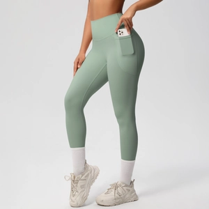 Sage green yoga pants side pocket detail with phone to show storage and matte fabric