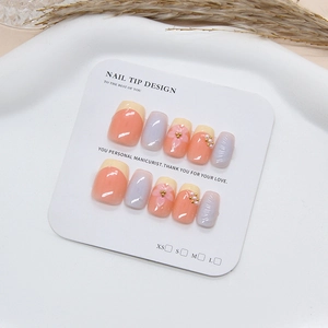 Handmade press-on nails set with 3D flowers, pearls, and pastel yellow peach French design