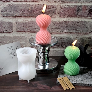 Dettaglio dello stampo in silicone per candele a spirale con cera testurizzata rosa e verde