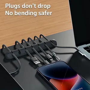 Black 7-slot silicone cable organizer for desk and car with adhesive backing