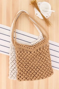Detail of handmade hollow-out crochet beach bag with sturdy braided shoulder straps