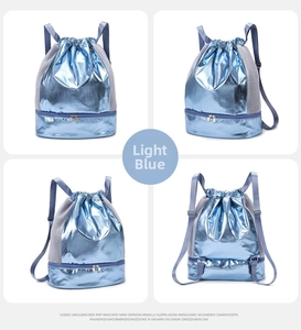 Detail view of light blue drawstring bag featuring a separate zipper bottom compartment