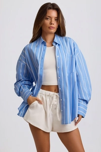 Detailed view of oversized blue striped shirt with white drawstring shorts and tank top
