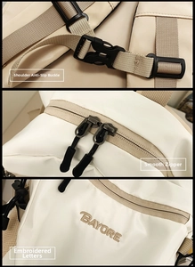 Detail view of anti-slip buckle, smooth dual zippers, and embroidered logo on backpack