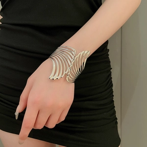 Macro view of silver hollow leaf pattern and polished layered metal texture of the cuff bracelet