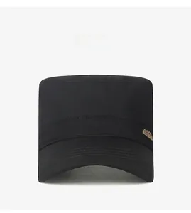 Close-up of black cotton cadet cap featuring a detailed golden mountain metal badge