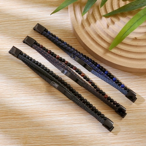 Detail of multilayer braided leather bracelets with beads and magnetic metal clasps