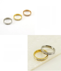 Detail of 18K gold plated stainless steel rings featuring sparkling zircon stones inlay