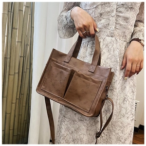 Brown vintage PU leather tote bag with dual front pockets and adjustable shoulder strap