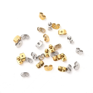 Macro shot of stainless steel butterfly earring backs in gold and silver finishes